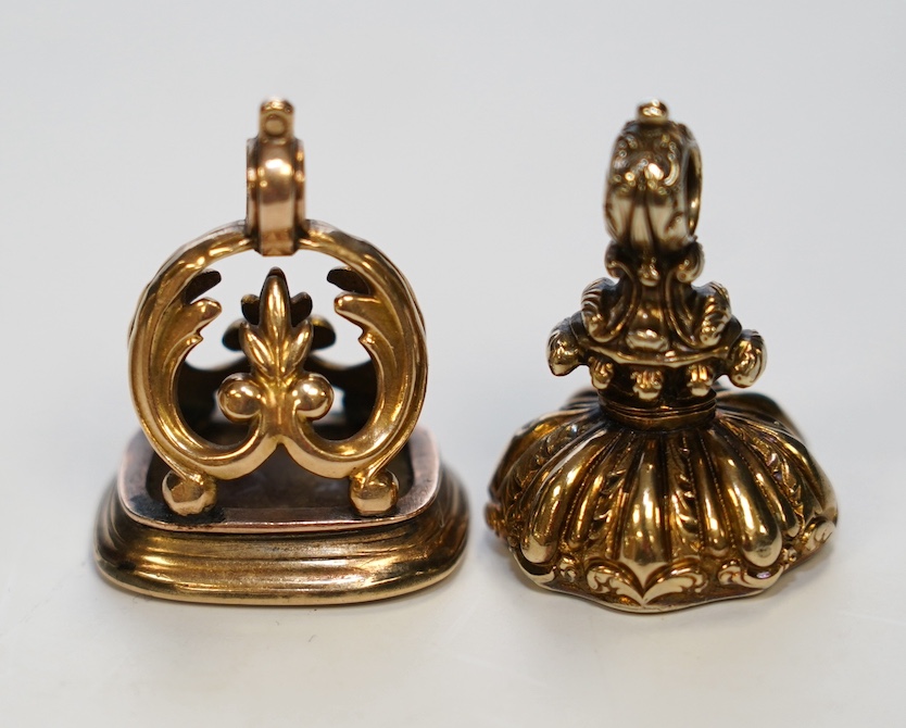 Two 19th century yellow metal overlaid and chalcedony set fob seals, largest 28mm. Condition - fair